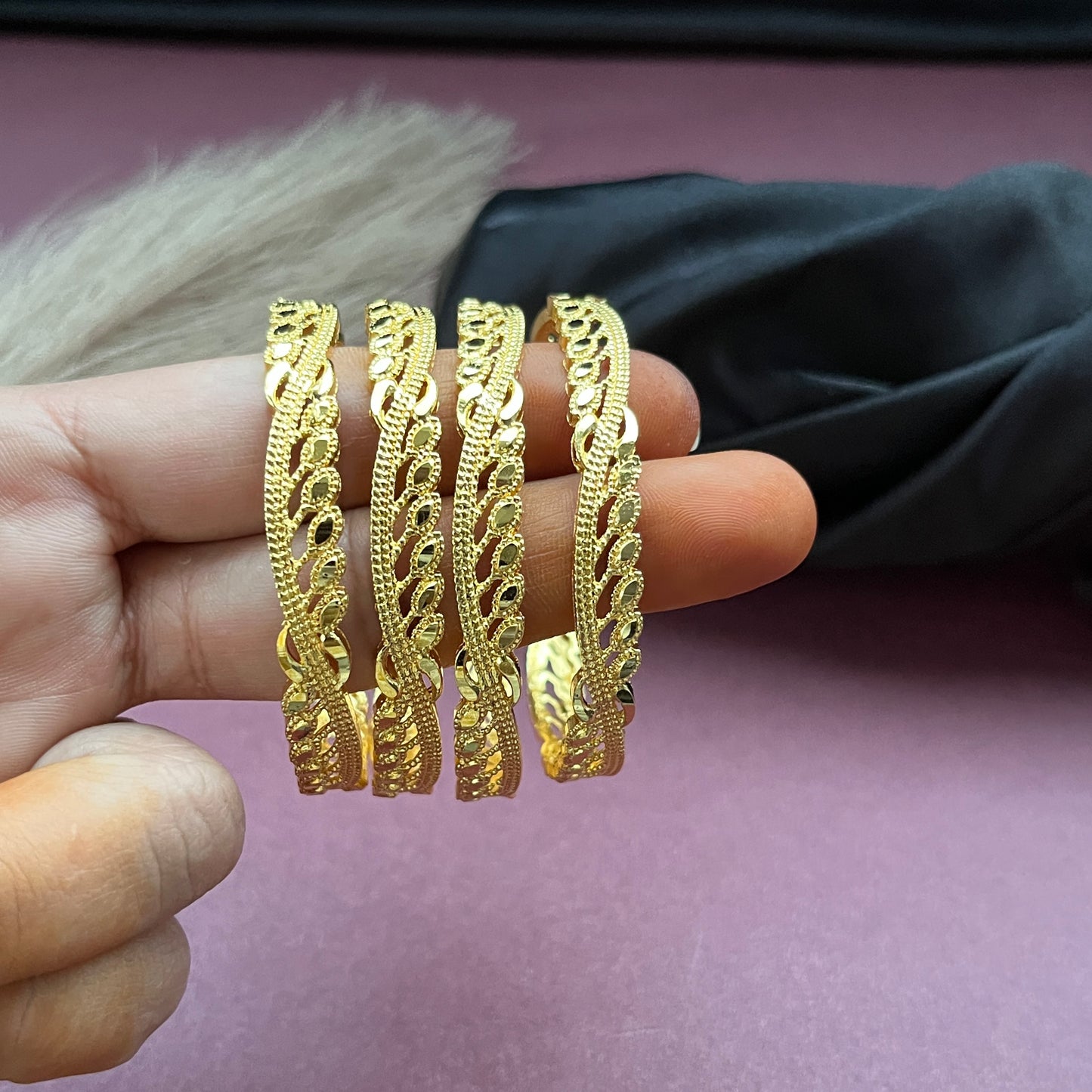 Traditional gold tone bangles with carved detailing imitation jewelry for weddings.Glossy gold look bangles in classic design party wear imitation bangles for women