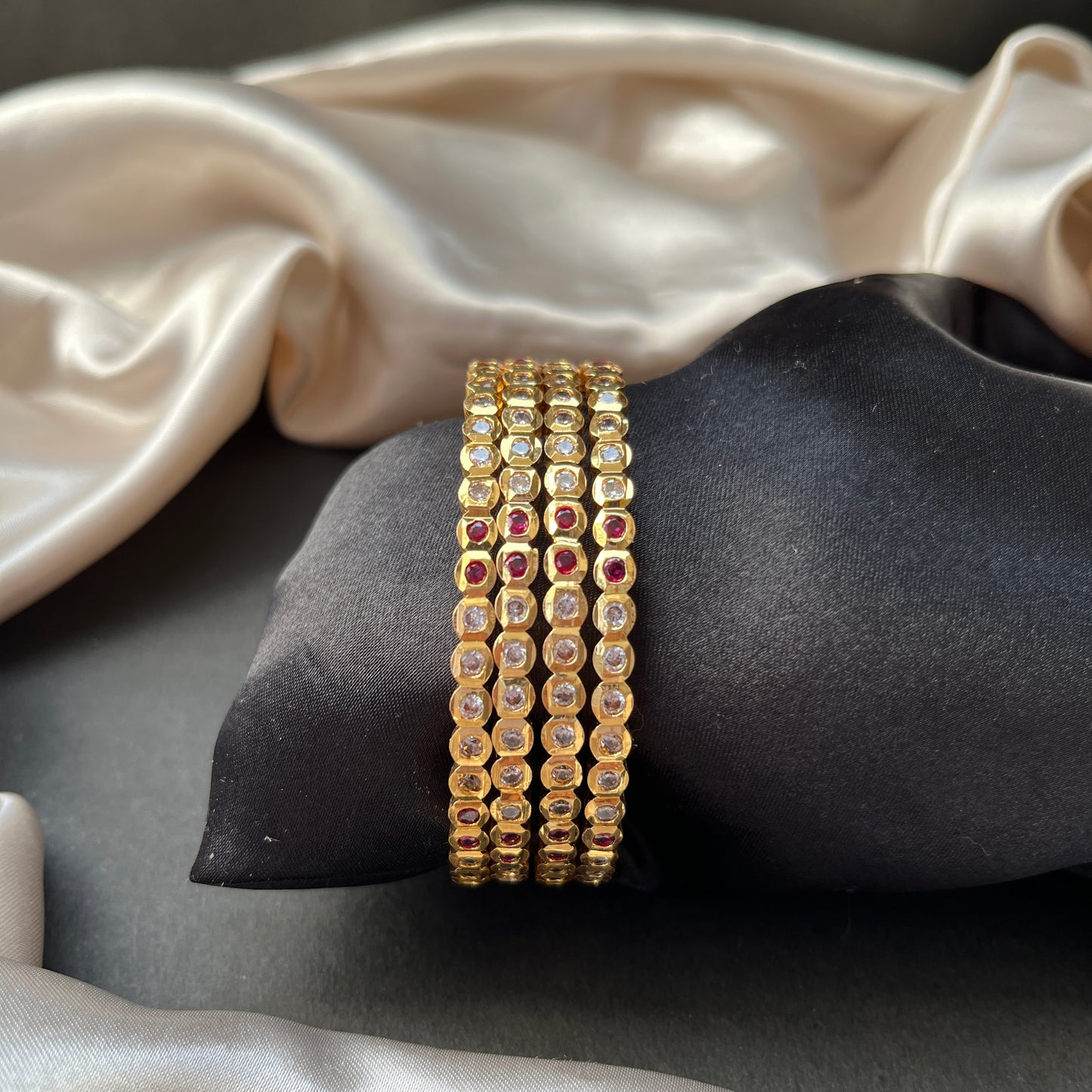 Traditional gold tone bangles with carved detailing imitation jewelry for weddings.Glossy gold look bangles in classic design party wear imitation bangles for women