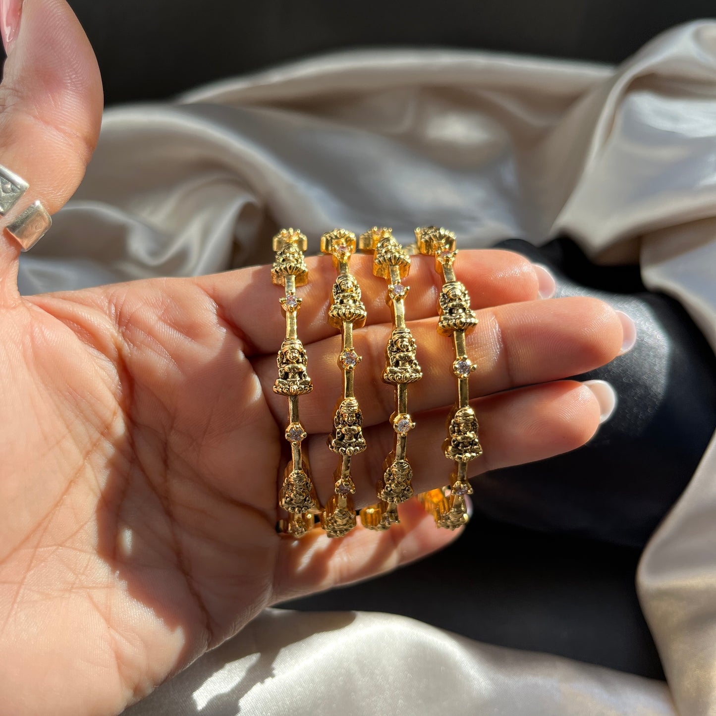 Traditional gold tone bangles with carved detailing imitation jewelry for weddings.Glossy gold look bangles in classic design party wear imitation bangles for women