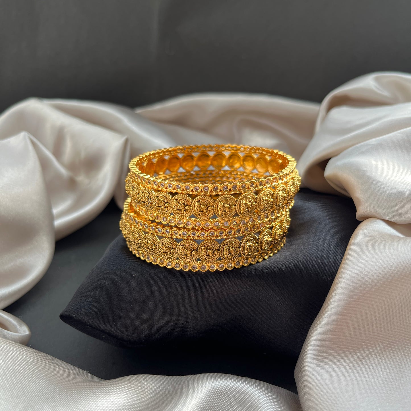 Traditional gold tone bangles with carved detailing imitation jewelry for weddings.Glossy gold look bangles in classic design party wear imitation bangles for women