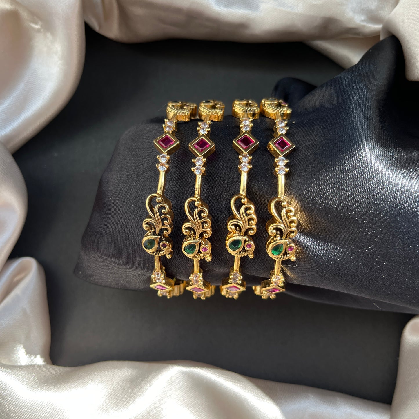 Traditional gold tone bangles with carved detailing imitation jewelry for weddings.Glossy gold look bangles in classic design party wear imitation bangles for women