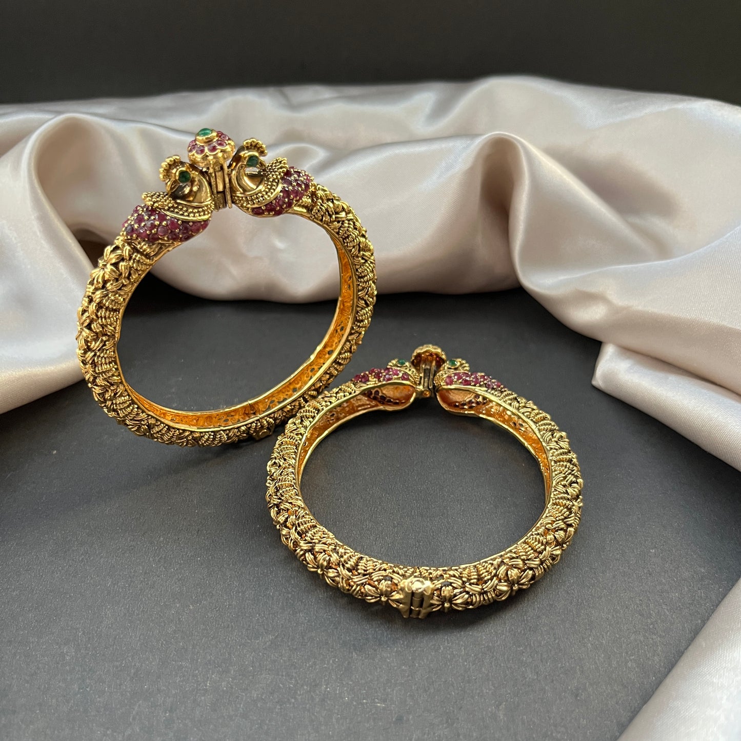 Traditional gold tone bangles with carved detailing imitation jewelry for weddings.Glossy gold look bangles in classic design β party wear imitation bangles for women