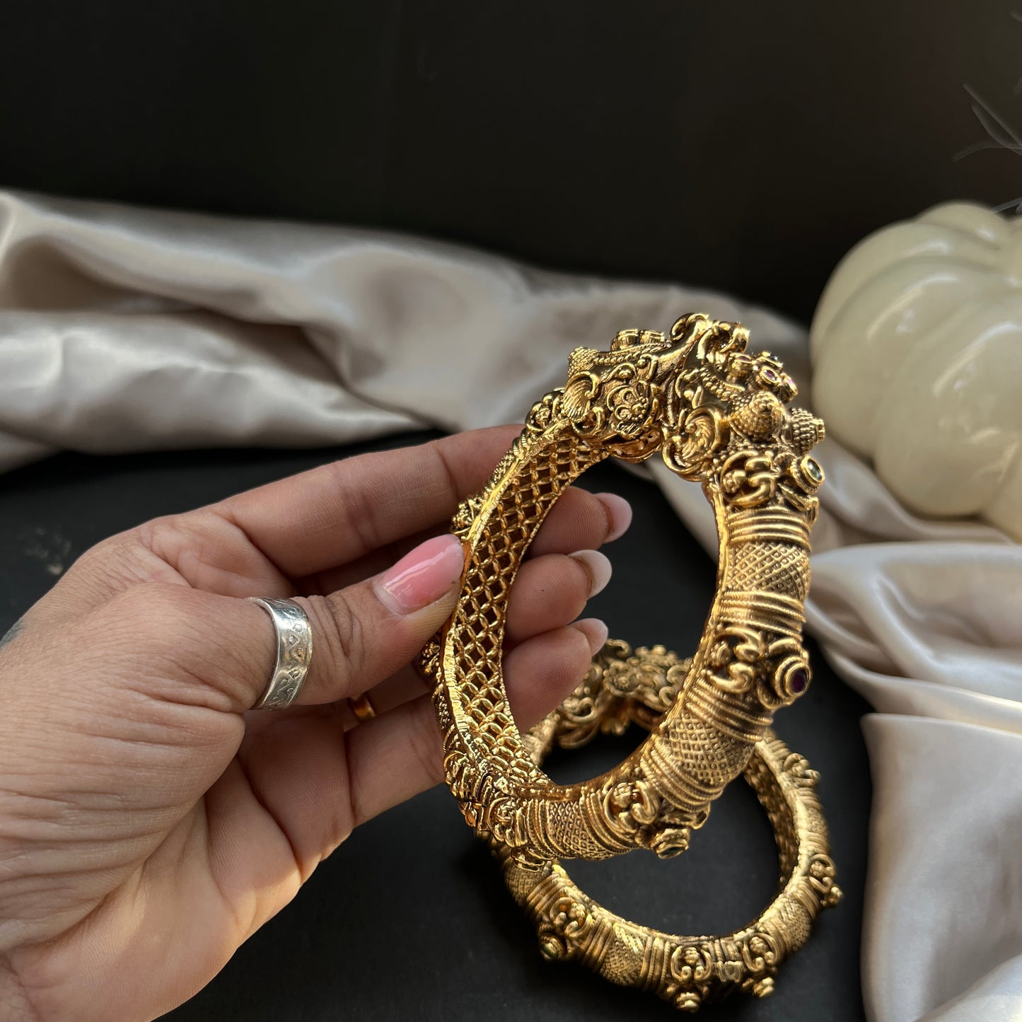 Traditional gold tone bangles with carved detailing imitation jewelry for weddings.Glossy gold look bangles in classic design party wear imitation bangles for women