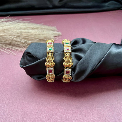 Traditional gold tone bangles with carved detailing imitation jewelry for weddings.Glossy gold look bangles in classic design  party wear imitation bangles for women