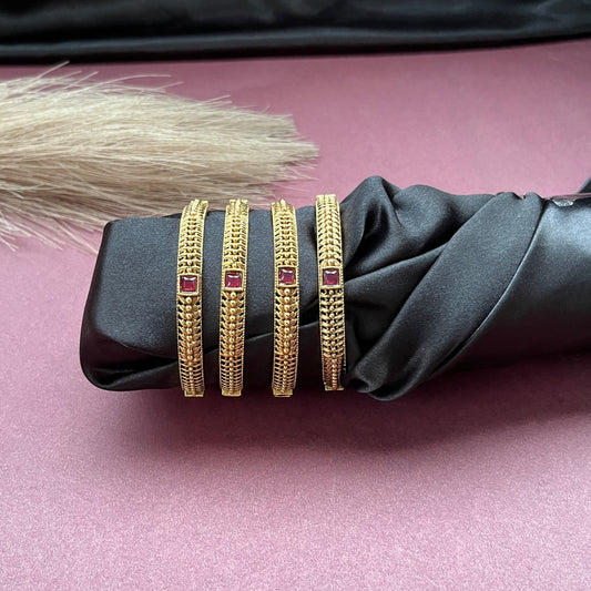 Traditional gold tone bangles with carved detailing imitation jewelry for weddings.Glossy gold look bangles in classic design  party wear imitation bangles for women