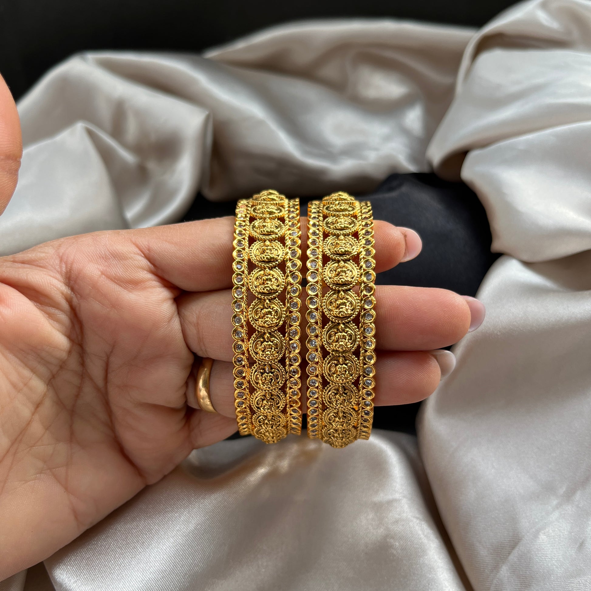 Traditional gold tone bangles with carved detailing imitation jewelry for weddings.Glossy gold look bangles in classic design  party wear imitation bangles for women