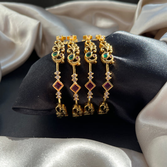 Traditional gold tone bangles with carved detailing imitation jewelry for weddings.Glossy gold look bangles in classic design  party wear imitation bangles for women