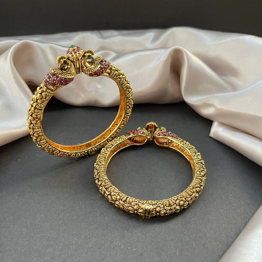Traditional gold tone bangles with carved detailing imitation jewelry for weddings.Glossy gold look bangles in classic design – party wear imitation bangles for women