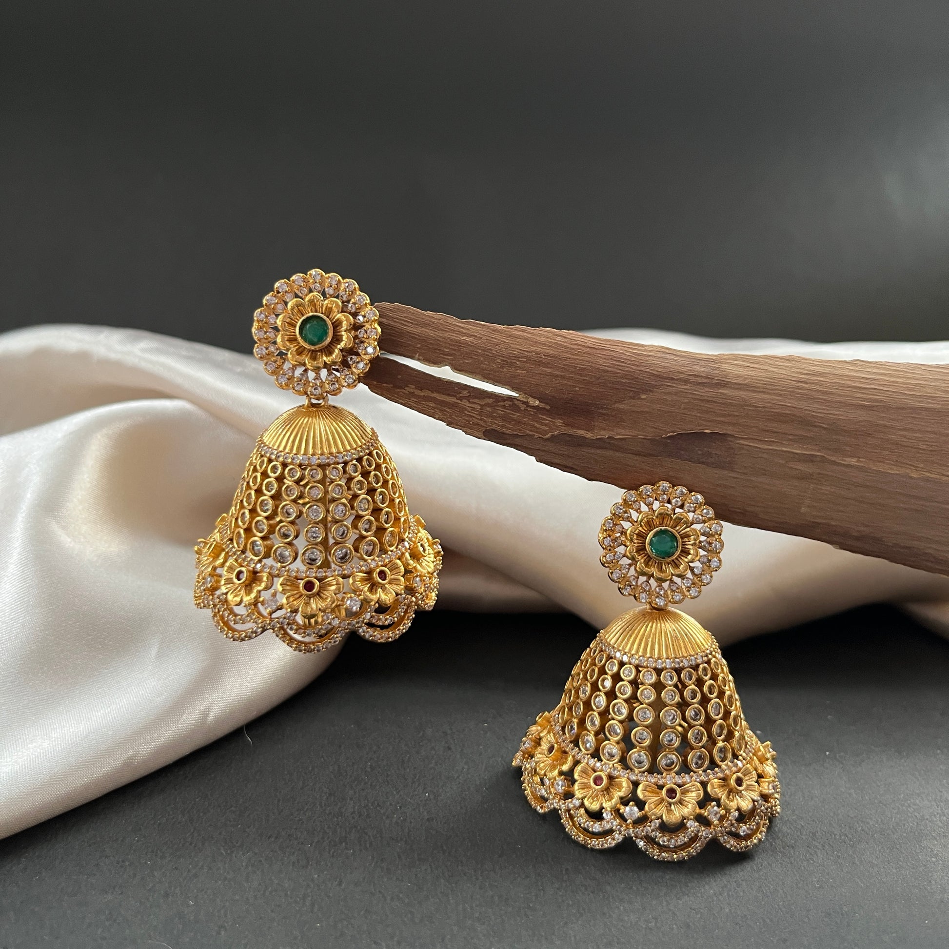 A timeless pair of jhumkis blending style and tradition, perfect for elevating any festive or everyday look

Weight - Light to Medium Weight

Note - 
Colour, shades, texture displayed may slightly vary from the actual product due to photography limitations. We humbly request you to consider these variations. We try our best to deliver the product pictures to 99% similar to the actual product