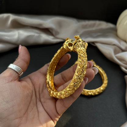 Traditional gold tone bangles with carved detailing imitation jewelry for weddings.Glossy gold look bangles in classic design  party wear imitation bangles for women