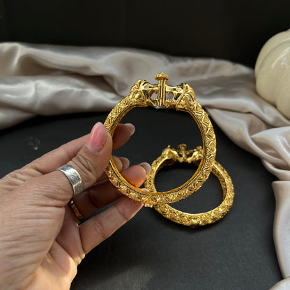 Traditional gold tone bangles with carved detailing imitation jewelry for weddings.Glossy gold look bangles in classic design  party wear imitation bangles for women